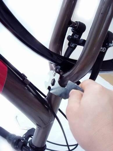 2. Using the spanner, loosen the nut on the front brake to allow enough room between the brake pads for the front wheel to