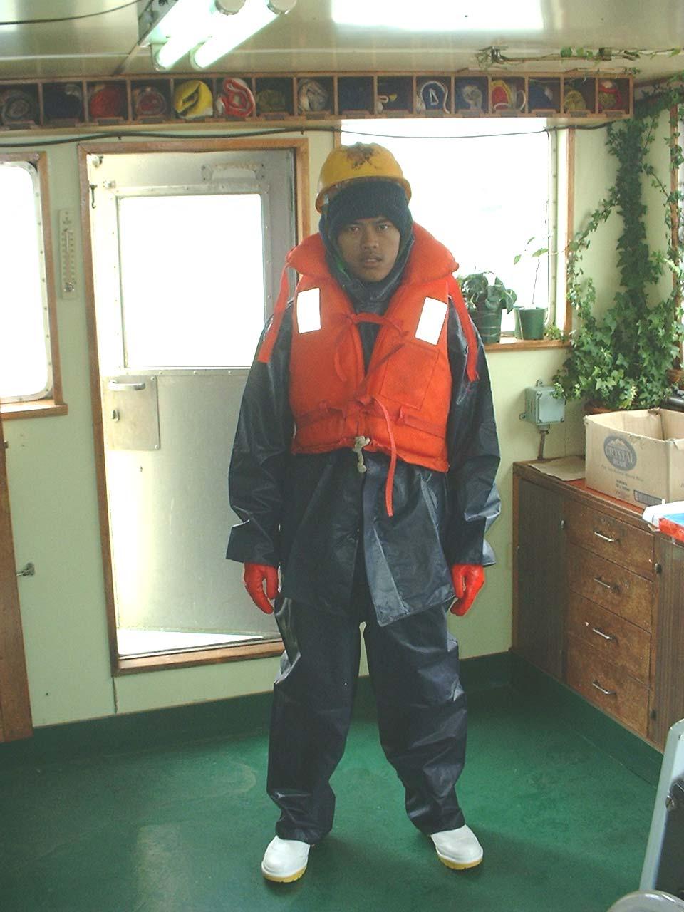 DECK GEAR AS WORN BY DECKHAND 1. At 0810 hours, Deckhand 1 and 2 were working on the net positioned near the main winches, situated forward and on the starboard side of the deck.
