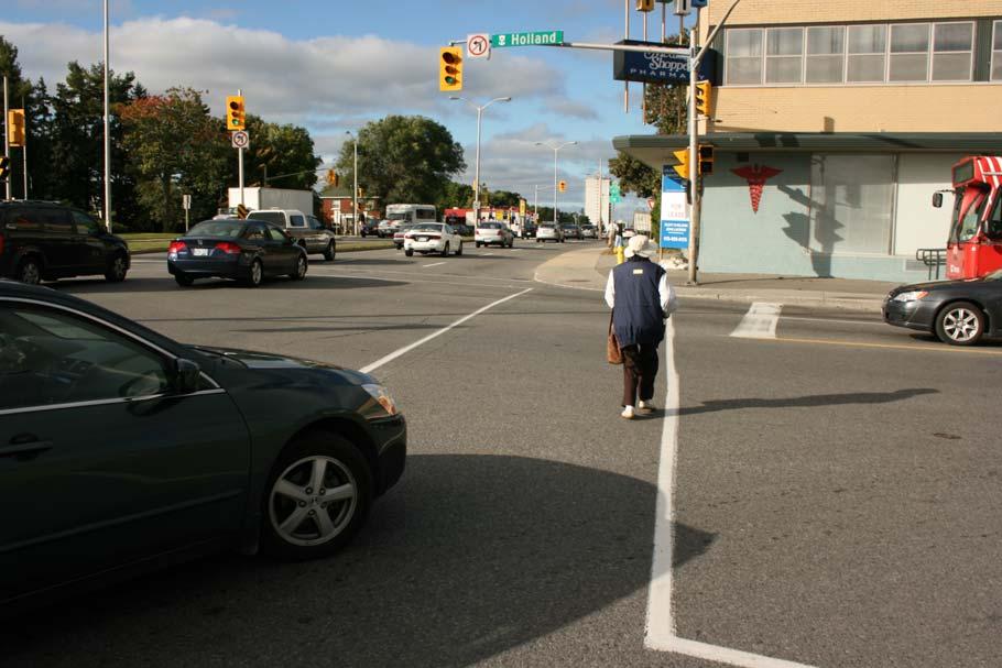 crosswalk to see oncoming traffic. Note the standing water that creates a hazard for pedestrians. (www.pedbikeimages.