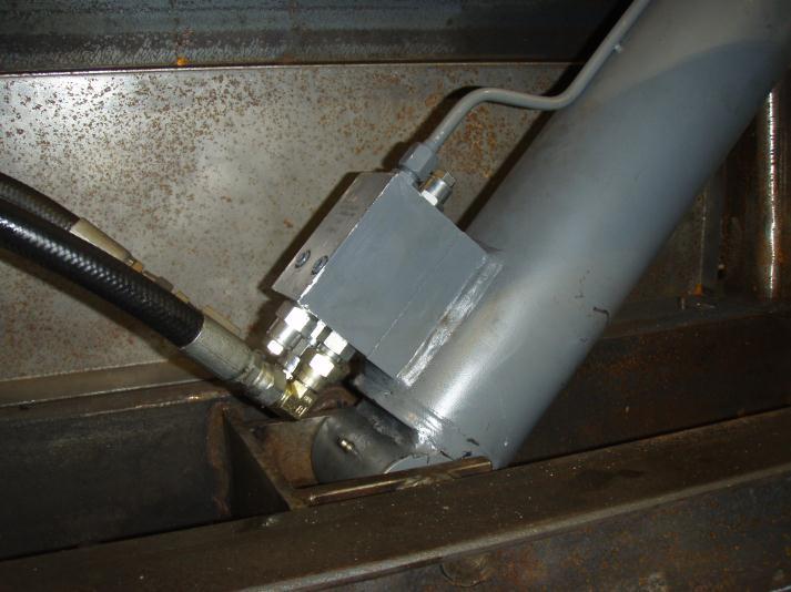 A This photo A, shows a counterbalance valve which is pad mounted directly to the hydraulic cylinder. This too has no means integrated to identify and safely vent the isolated fluid.