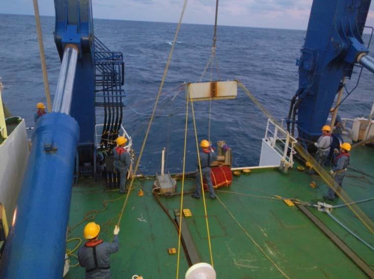 The wire was then run through a block on the A-frame, and the remaining subsurface instruments were installed at the rail. Figure 6: Mooring wire with instruments and fairings installed on deck.