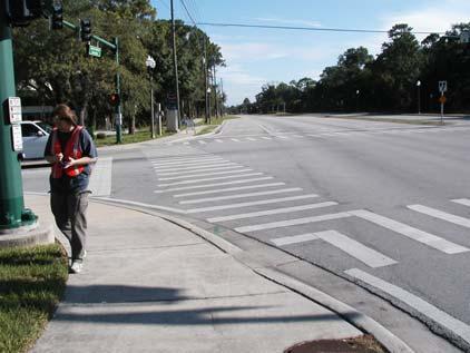 Clearly marked outside lanes define the roadway edge for motorists and increase the distance between the moving vehicle and the sidewalk user.