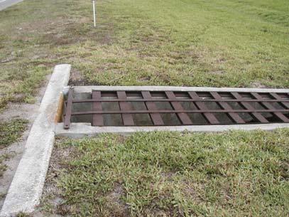 The proposed sidewalk can be aligned away from this structure but the grate will need to be