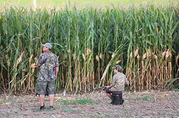 Hunting times, other than opening day, are one-half hour before sunrise until sunset. Photo above: Father, Son Dove hunting edge of corn field.-haynes Btm.