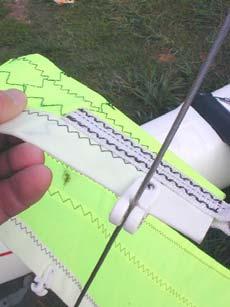 Clip the jib luff (the front edge of the sail) onto the forestay wire.