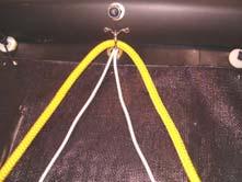 under the front cross beam. Tie a knot in the rope so the end of the rope cannot pass through the padeye.