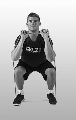 LOWER BODY SQUAT TO PRESS 1 Place the Pro Band on the ground, step onto the band, and stand shoulder-width apart.