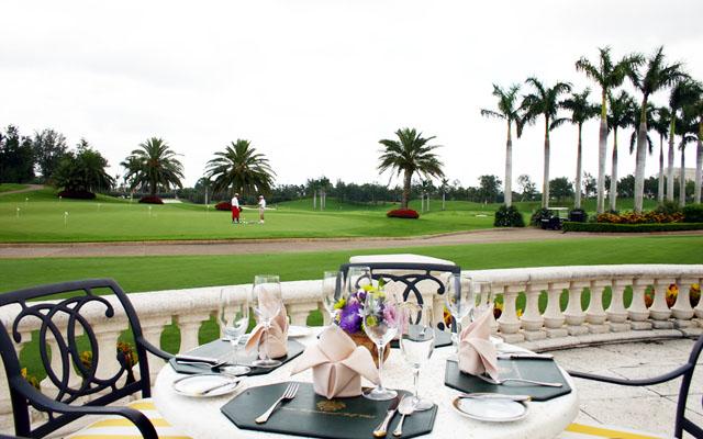 change to TifEagle. A tableside view of the new TifEagle practice putting green and the driving range from the patio of the clubhouse at Trump International Golf Club in West Palm Beach, Florida.