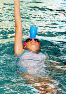 This is a training technique; The cup is a quarter-filled with water and the swimmer must