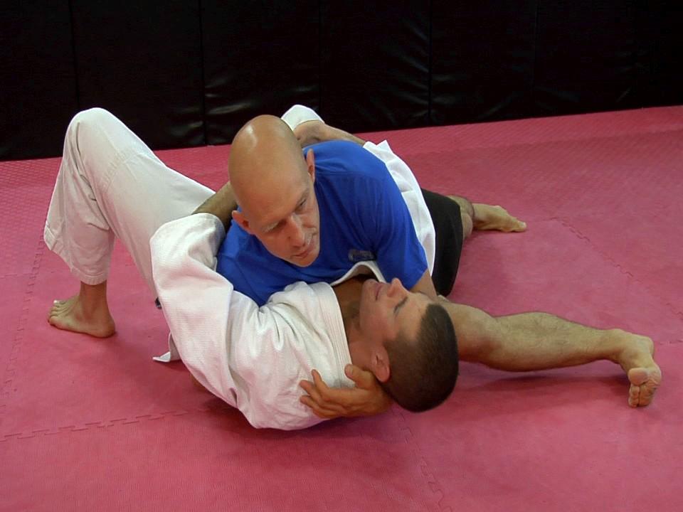 Pick your opponent up a bit, and put the far arm around his back. and on the floor, right under his diaphragm.