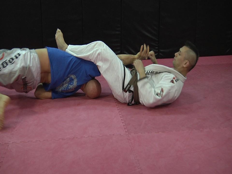 First, here's the technique with a partner: My opponent has caught me in an armbar.