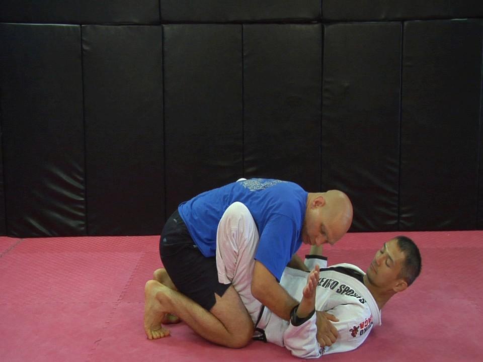 ) I use my hands on his shoulders to pummel him backwards until he s flat his back.