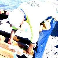 Worker installs/ removes items from a scaffold / platform [bending reaching and squatting].