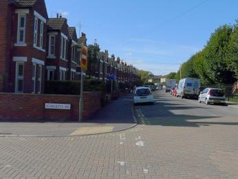 At a junction of footpaths where the approach path crosses the line of Parson s Lane (marked by a