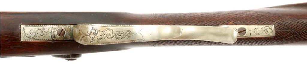 The silver trigger guard has very nicely executed foliate vines engraved on it.