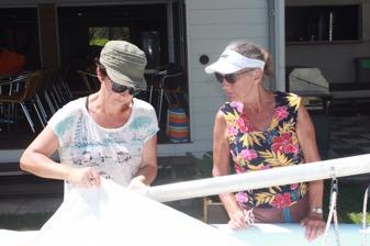 Joanne and Claire prepare to hoist the mainsail on one of the Vagabonds.