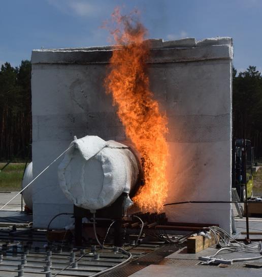 266 2. Experimental equipment Figure 1: The test equipment shown with an example fire. The tests were performed at the BAM technical safety test site (Droste et al.
