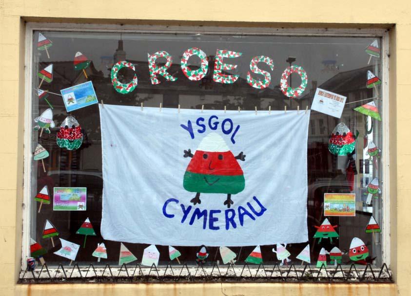 A Warm Welcome It is traditional by now that the local area welcomes the Eisteddfod by decorating houses, shops, streets, fields and many other things in Urdd colours which are red, white and green.