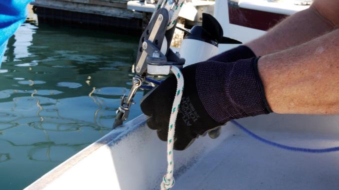 Secure the motor to the transom as far to port (not the side with the ladder) as