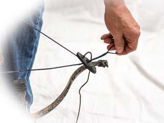 With your foot firmly in the stirrup, lift up on the Stringing Aid rope using the Rope Cocking Aid and latch it into the trigger utilizing the plastic wear tube. Figure 5 4.