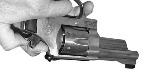 FIGURE 16 (2) Place the thumb of your firing hand on the hammer spur. You must always control the hammer with your thumbs when decocking the handgun.