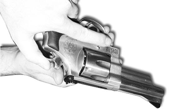 FIGURE 17 (3) Apply pressure to the trigger to release the hammer as shown (FIG- URE 17).