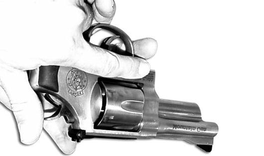 FIGURE 18 WARNING: FAILURE TO REMOVE YOUR FINGER FROM THE TRIGGER GUARD AS SOON AS THE HAMMER RELEASES COULD CAUSE THE REVOLVER TO FIRE IF YOUR THUMB SLIPS OFF OF THE HAMMER SPUR.