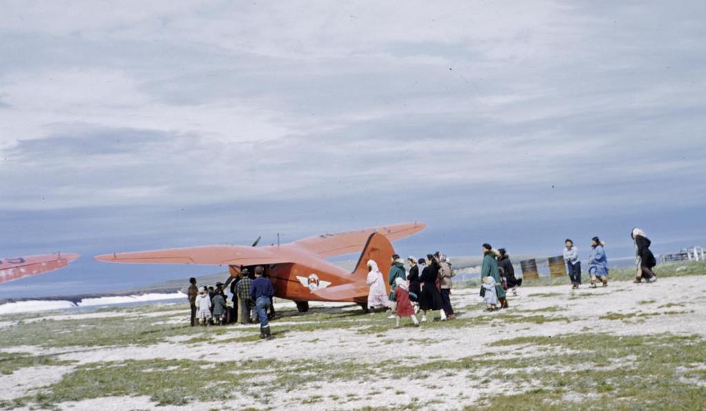 Arrival at Deering, Alaska-Villagers gathered at landing strip to meet mail plane "From Fairbanks we fly over Alaska to Kotzebue (Kot-ze-bue) Sound, on the Bering Sea, where we will