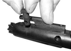(Figure 29) Give the bolt cam pin a 1/4 turn and lift it out. (Figure 30) Remove the bolt from the bolt carrier.