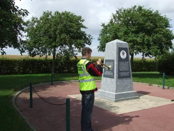 Cdt David Folder of 1284 (Tenby) Sqn plays the Last Post at the Royal Welch Fusiliers/Operation Greenline Memorial at Evrécy.