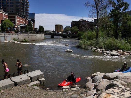 Paddlers Ben Spillman, left, and Noah Fraser navigate some class II rapids on the Truckee River in the Reno/Sparks area on May 13, 2016.