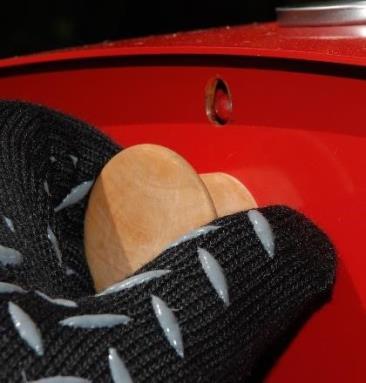 Using the Firepod heat-resistant gloves, lift the door slightly until the hole lines up with the catch and