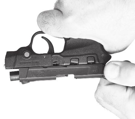 Remove the slide from the frame by pushing it forward with your thumb while being careful to retain the recoil