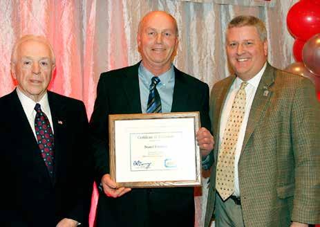 Jay Wolf (R) and Jerry Knappenberger (L) present Brad Wallace (C) with