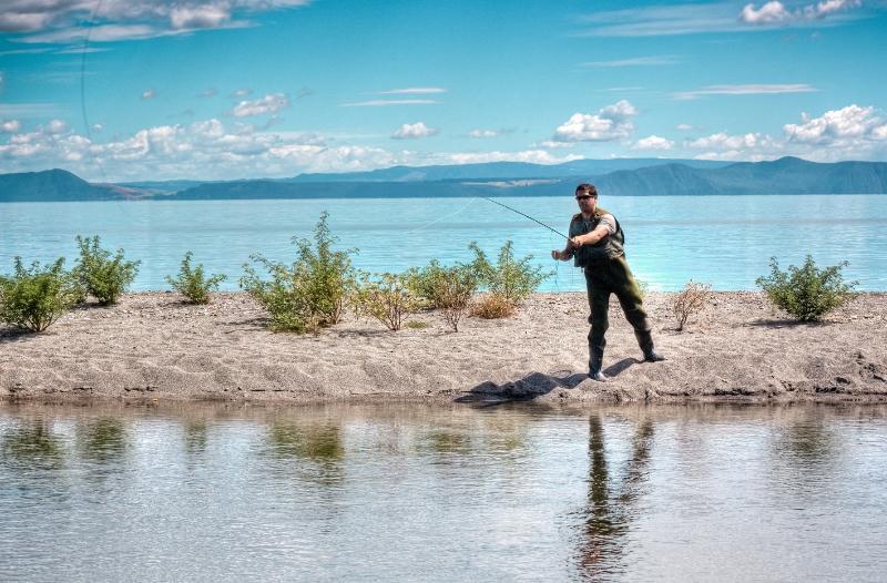 After a days riding, relax on the shores of Lake Taupo and enjoy a spot of fly fishing.