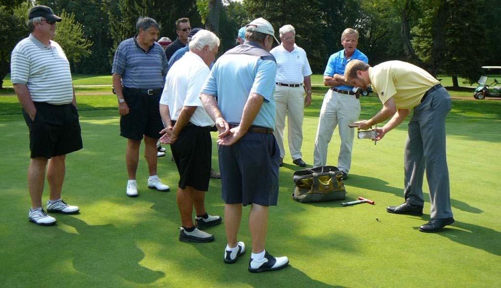 Ty McClellan shows Ridgemoor Country Club golfers a nice rootzone from a USG-constructed green.