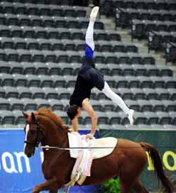 A young German vaulter performs an open-hip mount at the 2010 World Equestrian Games. Maintain alignment by squaring the hips and facing forward, not toward the horse.