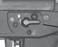 and above the trigger. The safety levers may be operated from either side.