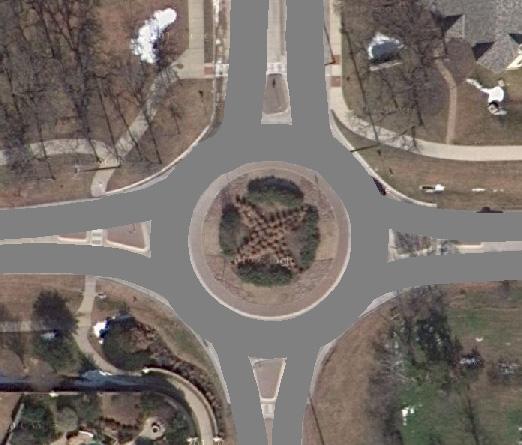 For VISSIM, an aerial image of the intersection was imported and scaled, and links and connectors were organized over the image to match the geometry of the roundabout. This is depicted in Figure 4 4.
