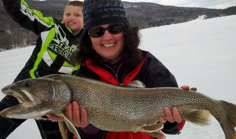 Pond of Safety. (Photo Credit: Plymouth State University) DES Biologist Amy Smagula holding a lake trout.