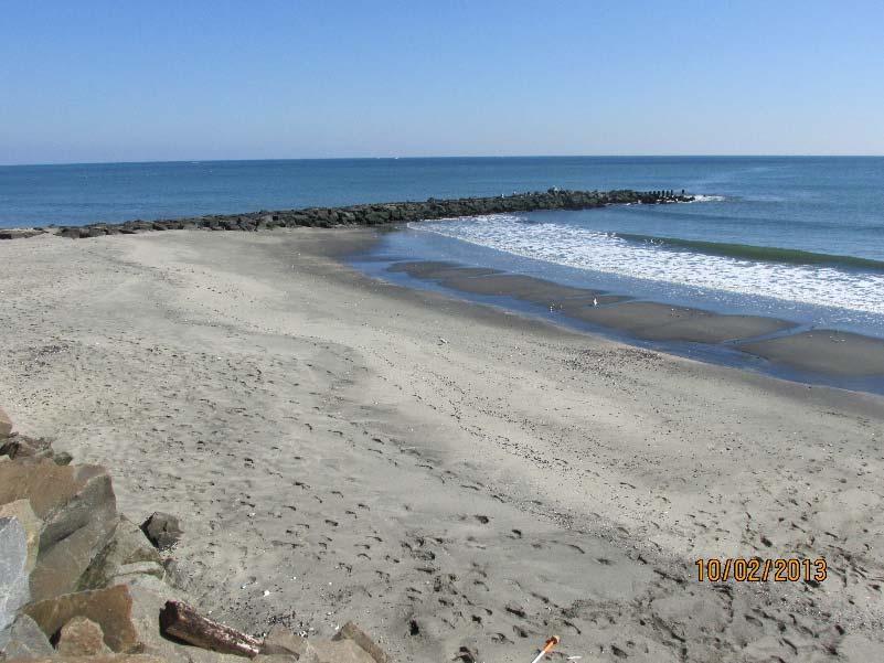 The photo on the left (taken November 13, 2012) shows the impacts of Sandy where waves crashed over the rocks and dug deeply into the area just landward of the rock revetment.