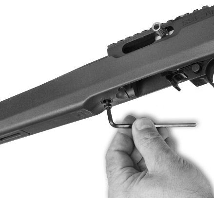 Once the action is seated against the rear of the opening in the stock, apply thumb pressure to the receiver near the peep sight and tip the barrel down into