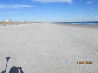 The dry beach is double the width seen in June, 2013 but the appearance is deceptive as the beach elevation is less than 4-5 feet NAVD88.