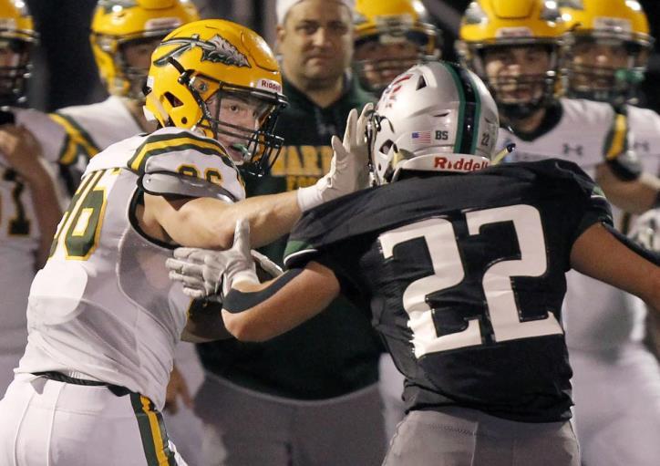 Mansfield fends off King Philip By Peter Gobis King Philip Regional High wide receiver David Morganelli, left, stiffs-arms Mansfield High linebacker Vinnie Holmes after making a catch in the first