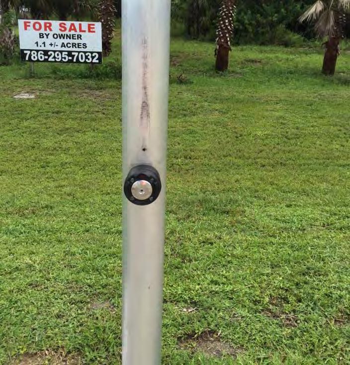 The field review team observed pedestrians pushing both buttons on the pole to cross Palm Bay Road because the signage was unclear.