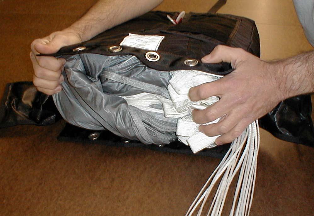 Continue S -folding the canopy into the deployment bag.