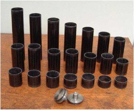 Figure 1: The models and their end bungs The models consisted of a mixture of carbon and glass fibre layers. The manufacturer was Carbon Fibre Tubes Ltd, Hayling Island, UK.