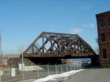 4.13 Fitchburg Line (former Red Bridge) Existing Conditions: The New Hampshire Main Line formerly crossed over the Fitchburg Line and Grand Junction via a steel truss structure.