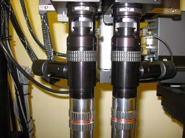 Figure 4. The focus for the video optics column is the rubber ring on each column. The zoom power can be adjusted with the black metal ring above the focus.