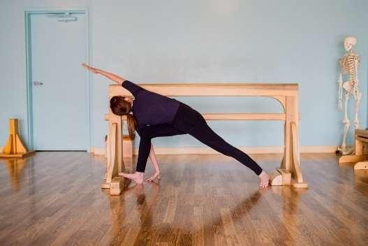 Bending the back leg will give stability, allowing you to deepen the twist and reach your hand to the floor.